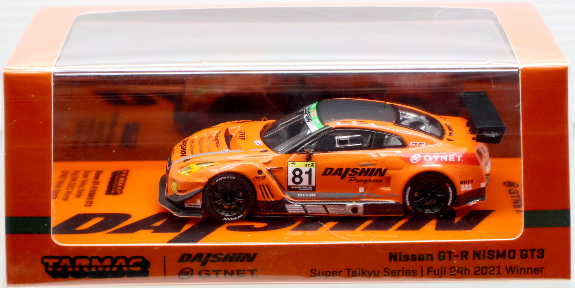 A 1/64 scale die-cast model of the Nissan GT-R NISMO GT3, winner of the 2021 Fuji 24 hours Super Taikyu Series by GTNET Motor Sports, produced by Tarmac Works. The model features detailed rims, rubber wheels, front and rear lights, and comes packaged in special packaging. Limited production run with SKU T64-035-21ST81 and barcode 9580015718851. Fully licensed product from Tarmac Works. Available at TatoyShop.com.